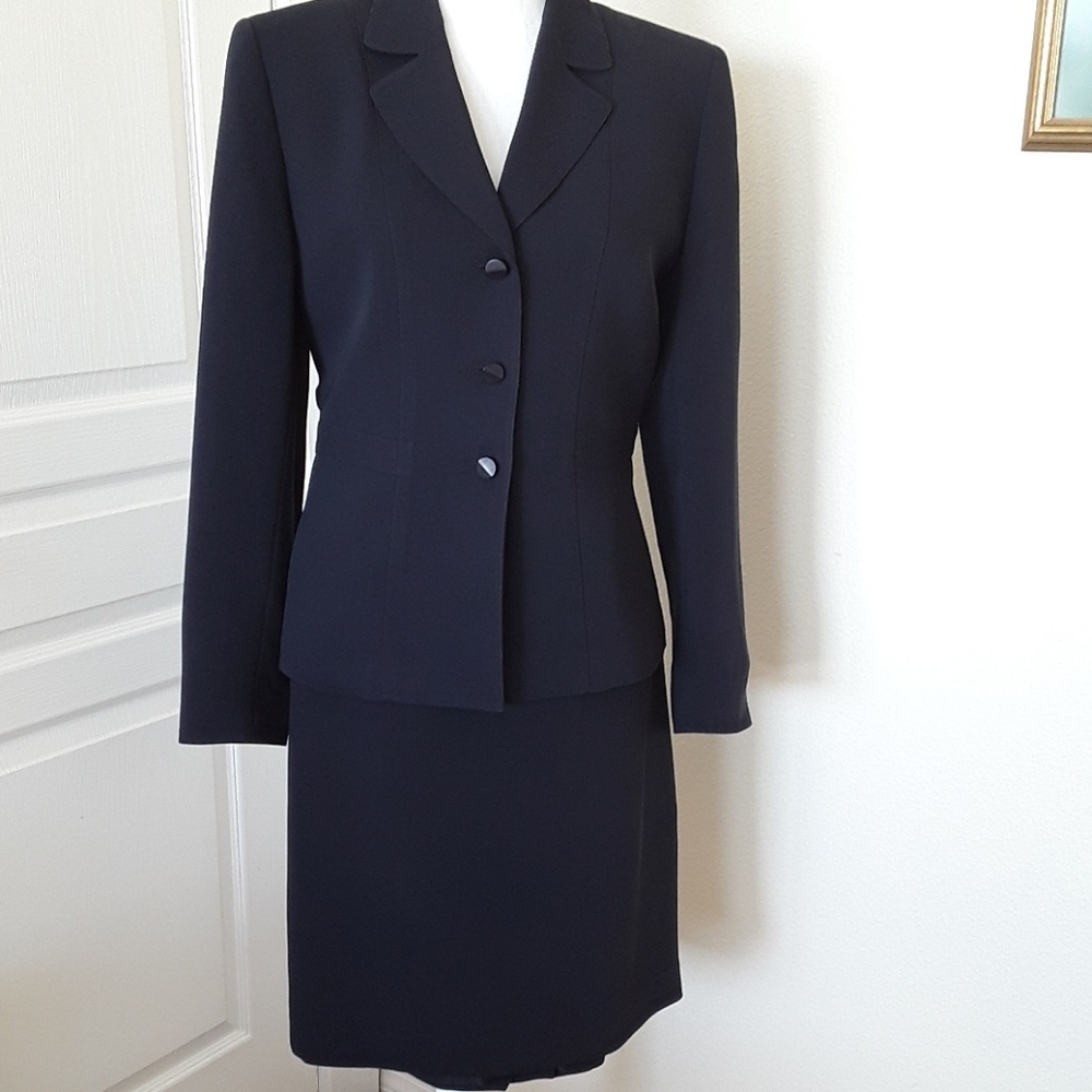 Skirt suit, three button jacket closing.